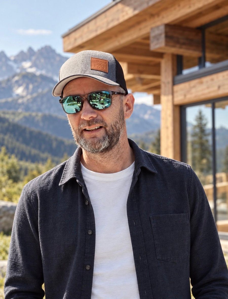 Christoph J. Sorg in front of a timber building in the mountains